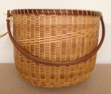 10" traditional Nantucket. Walnut staves rim base and handle tripe step in weaving $350